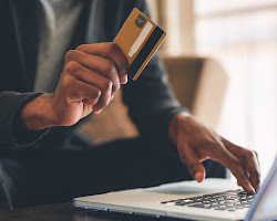 person paying off debt with a credit card