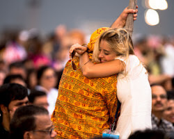 person hugging a local after a community festival
