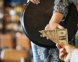 waiter receiving a tip from a customer