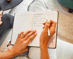 person writing down their financial goals