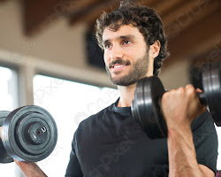 Person smiling and lifting weights