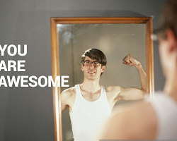 Person smiling and looking at themselves in the mirror