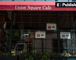 group of people dining at a restaurant that is experimenting with new ways of compensation