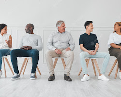 group of people sitting in a circle, listening to a story