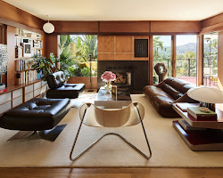 living room with a mid-century modern sofa and a 1970s-inspired rug