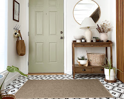 person placing a doormat at an entryway
