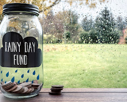 person with a jar labeled "emergency fund"