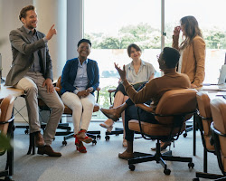 person working in an office with people from different cultures