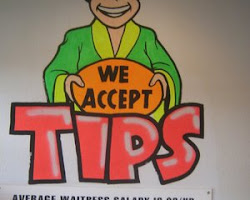 sign at a restaurant that says "We accept tips"